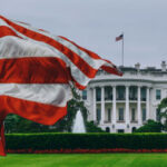 U.S. flag waving in front of the White House.