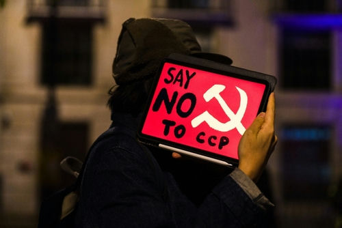 Person holding sign saying Say No to CCP