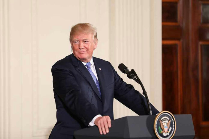 Person speaking at podium, presidential seal on front.