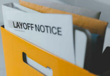 Folder with layoff notice in yellow box.