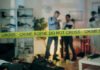 Crime scene tape in front of investigators and forensic unit.