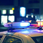 Police car with flashing lights at night.