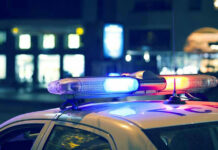 Police car with flashing lights at night.