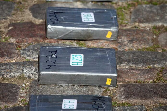 Gray taped packages lying on a cobblestone surface