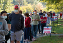 People standing in line for curbside voting on an autumn day
