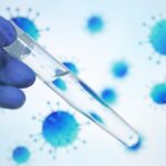 War-Zone BIO-LABS Probe REVEALS HUGE SAFETY Questions A gloved hand holding a test tube with a clear liquid against a blue virus background