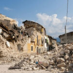 Quake AFTERMATH Exposes UNEXPECTED Findings Rubble from collapsed buildings in earthquake-hit area. Clear sky.
