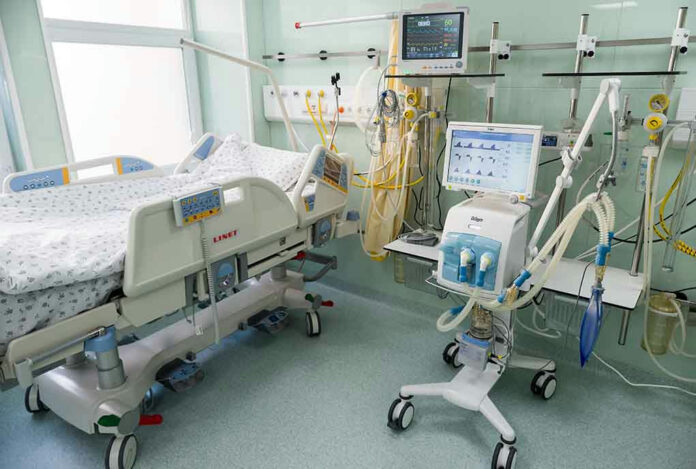 Hospital bed with medical equipment and monitors.