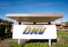 California DMV building with sign and greenery