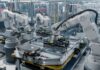 Robotic arms working on an assembly line in a modern factory