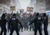 WHIPLASH Inside ICE After Shootings Protesters holding signs against ICE in a snowy urban setting