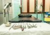 Gynecology exam room with table and surgical instruments