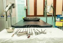 Gynecology exam room with table and surgical instruments