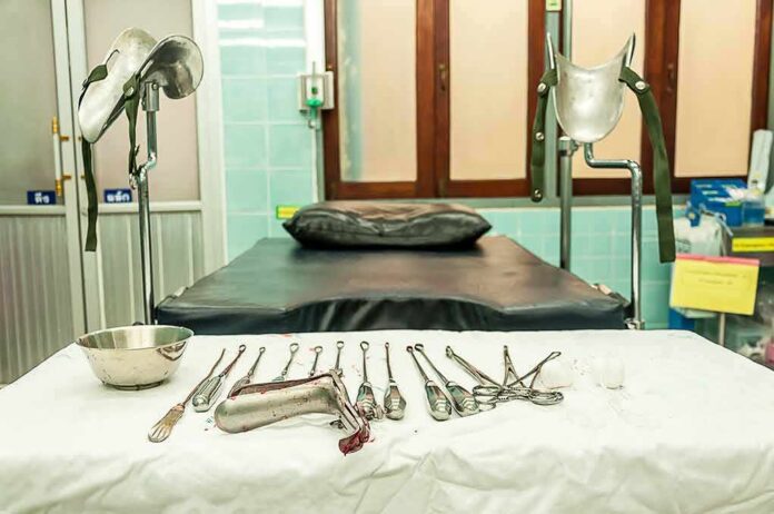 Gynecology exam room with table and surgical instruments