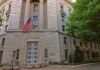 Stone government building with American flag at entrance