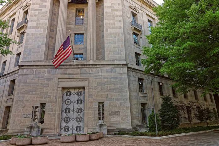 Stone government building with American flag at entrance