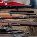 Old rifles displayed on a table