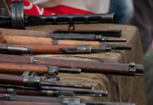 Old rifles displayed on a table