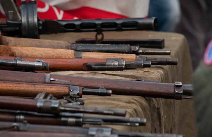 Old rifles displayed on a table