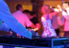 DJ playing music at a lively dance event.