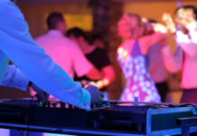 DJ playing music at a lively dance event.