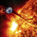 Earth near erupting sun with solar flare visible.