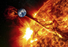 Earth near erupting sun with solar flare visible.