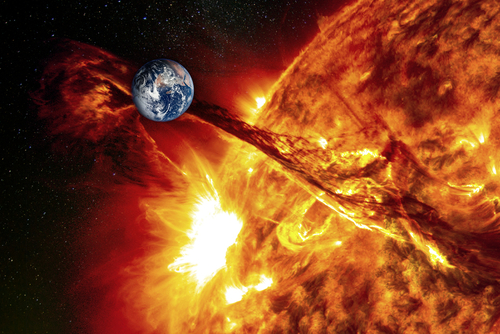 Earth near erupting sun with solar flare visible.