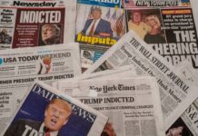 Newspapers with headlines about Donald Trumps indictment.